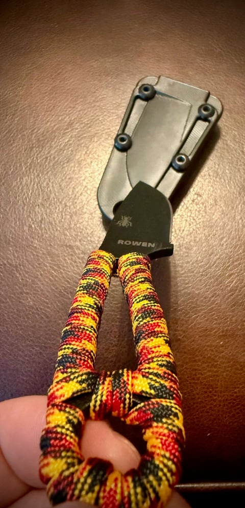 ESEE Izula with custom Oktoberfest paracord wrapped handle and trident bead