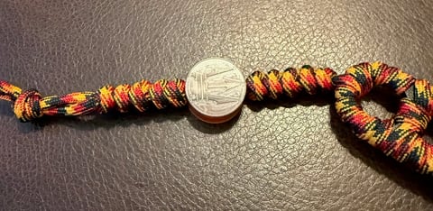 ESEE Izula with custom Oktoberfest paracord wrapped handle and trident bead