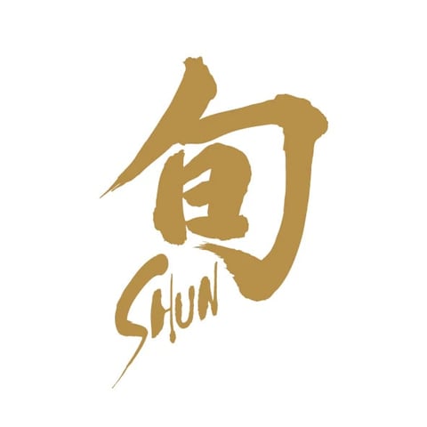 Gold hand-drawn logo featuring stylized Asian characters with brushstroke design and the word SHUN