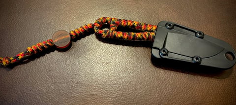 ESEE Izula with custom Oktoberfest paracord wrapped handle and trident bead